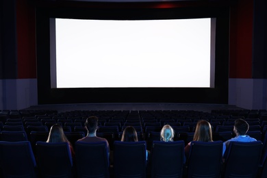 Photo of Young people watching movie in cinema theatre. Space for text