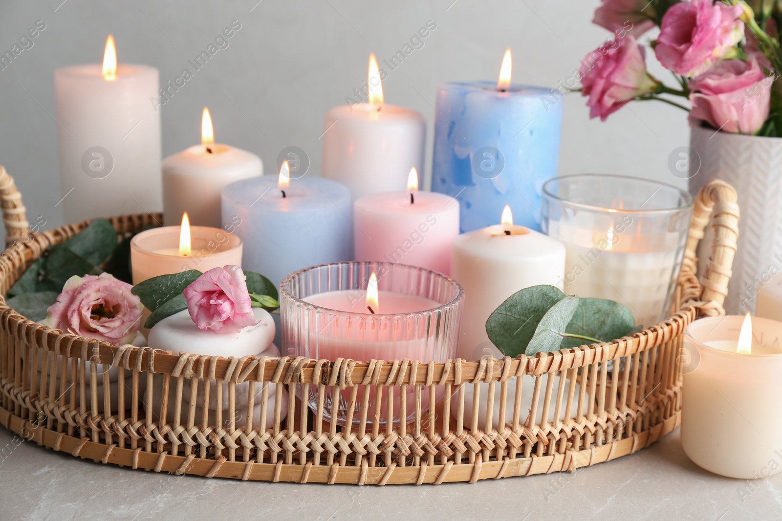 Photo of Composition with burning candles on light grey table
