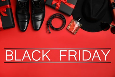 Photo of Flat lay composition with gift boxes, male accessories and phrase Black Friday on red background