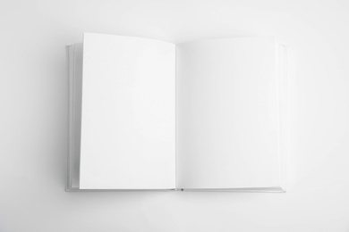 Photo of Open book with blank pages on white background, top view