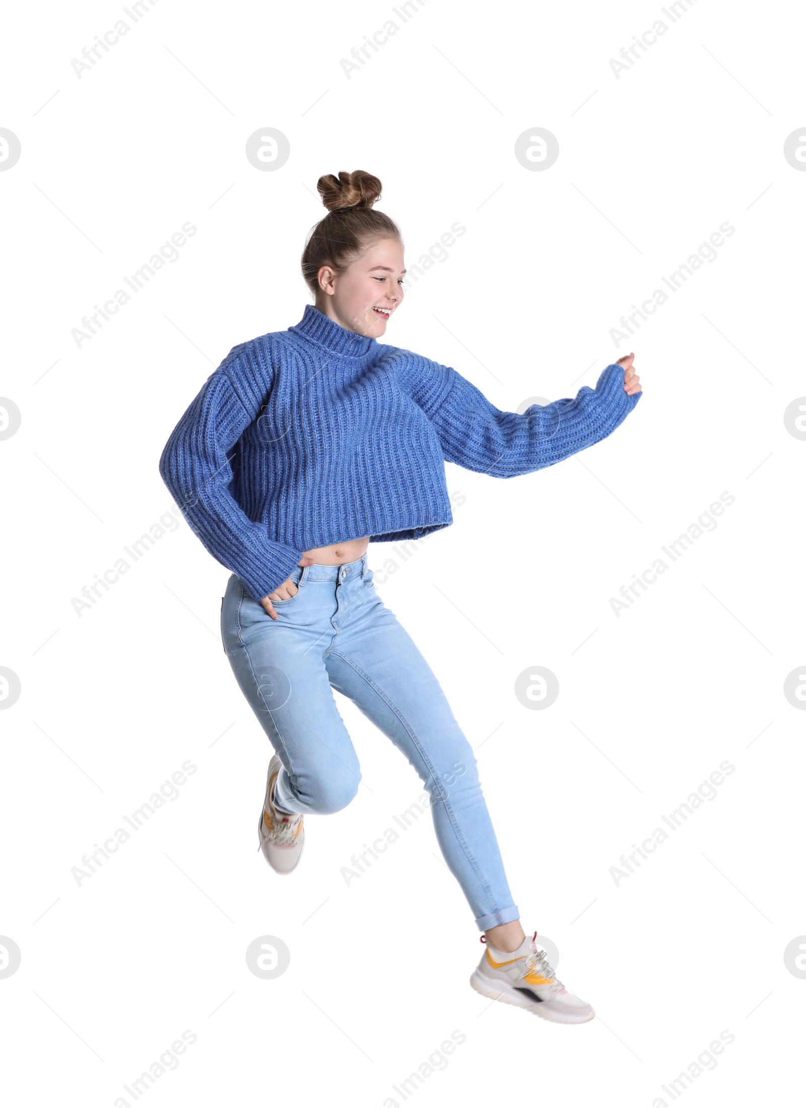 Photo of Pretty teenage girl jumping on white background