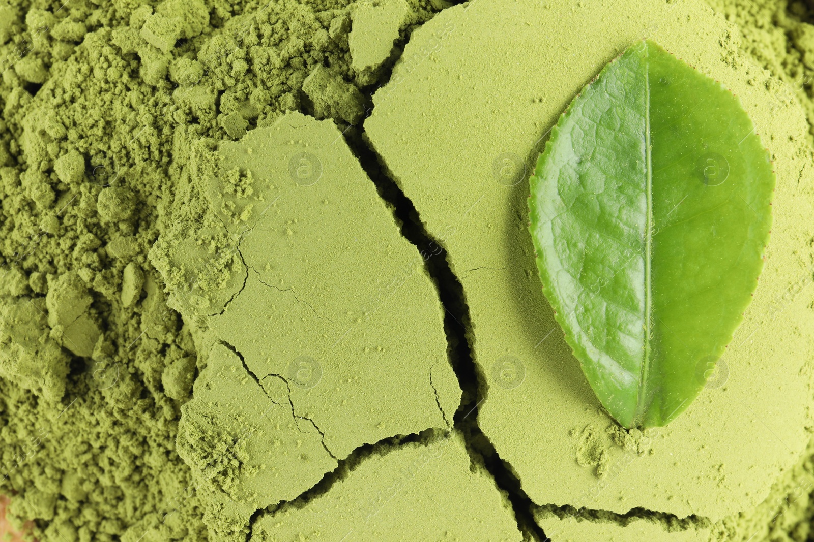Photo of Green matcha powder and leaf as background, top view