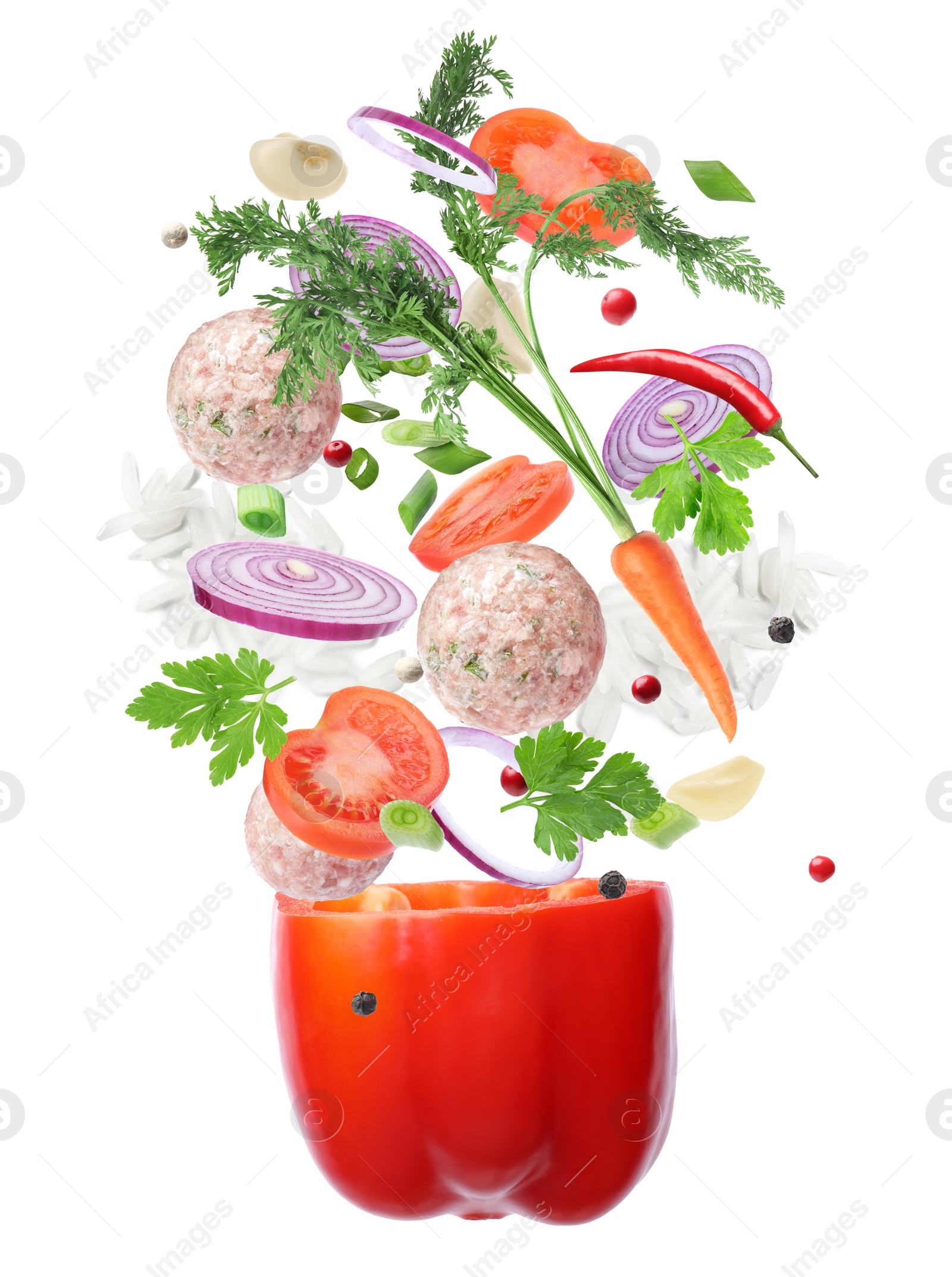 Image of Stuffed pepper recipe. Fresh ingredients falling into bell pepper on white background