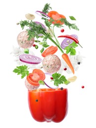 Image of Stuffed pepper recipe. Fresh ingredients falling into bell pepper on white background