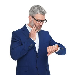 Photo of Mature businessman in stylish clothes checking time on white background