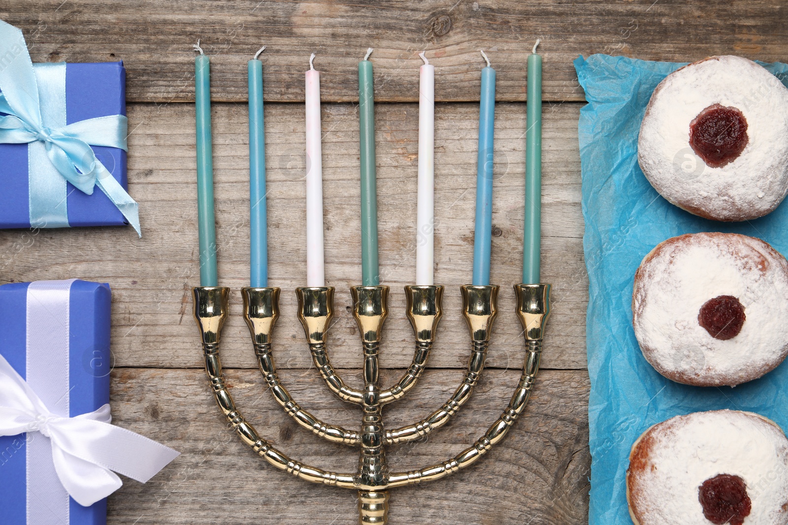 Photo of Flat lay composition with Hanukkah menorah and gift boxes on wooden table