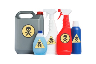 Photo of Bottles of toxic household chemicals with warning signs on white background