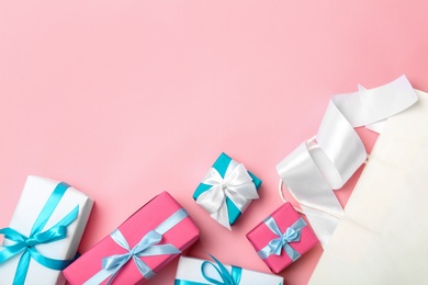 Photo of Flat lay composition with shopping bag and gifts on color background
