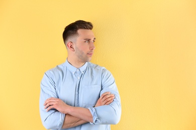 Portrait of young man with beautiful hair on color background