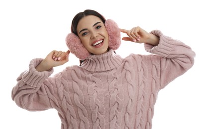 Photo of Beautiful young woman wearing earmuffs on white background