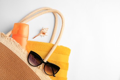 Photo of Flat lay composition with sunscreen and beach accessories on white background, space for text