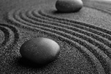 Black sand with stones and beautiful pattern. Zen concept