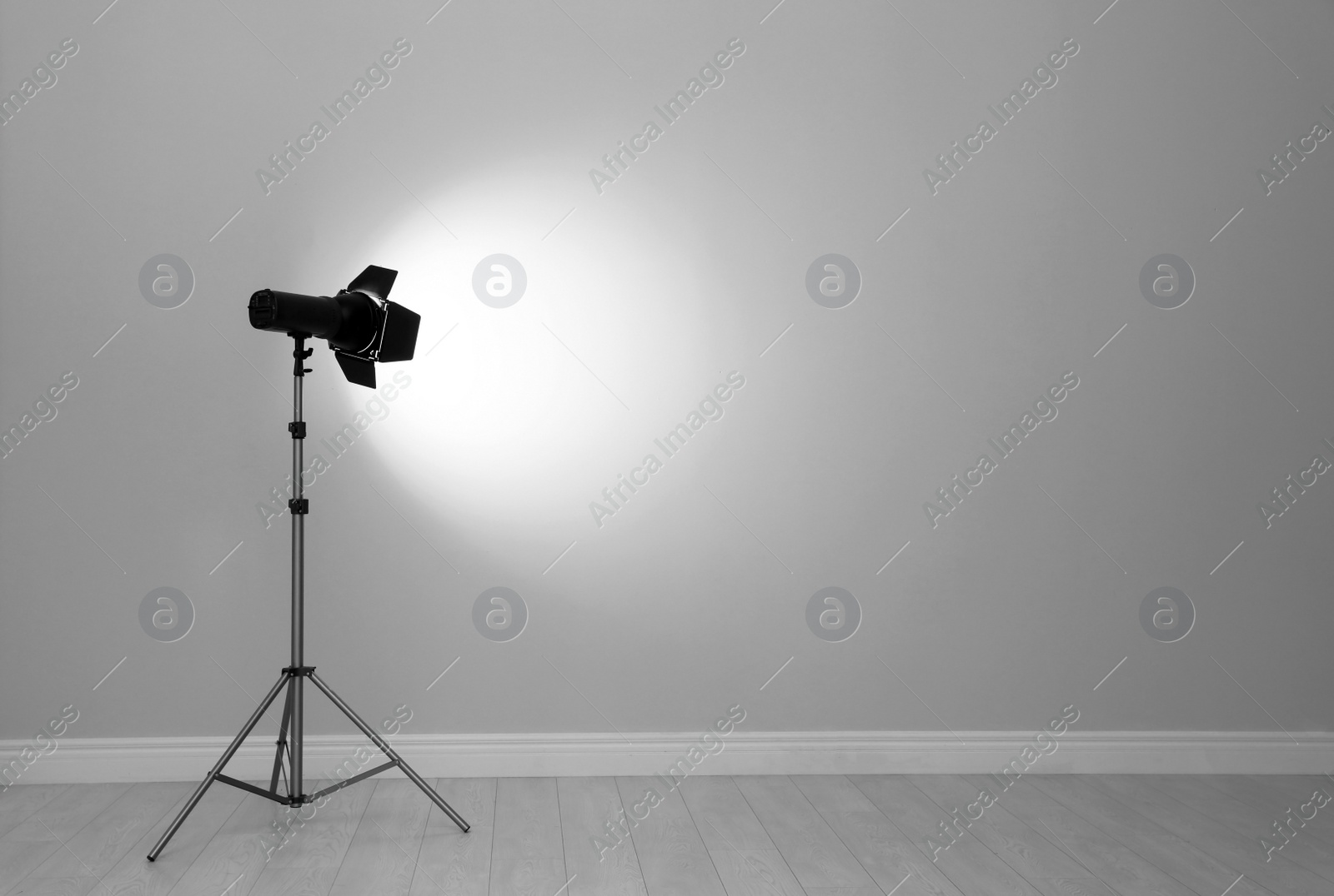 Photo of Professional lighting equipment near wall in photo studio. Space for text