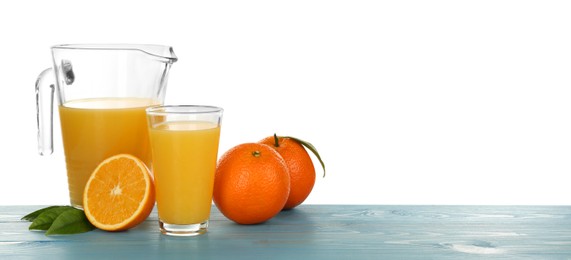 Photo of Delicious orange juice and fresh fruits on light blue wooden table against white background. Space for text