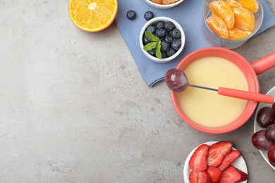 Photo of Flat lay composition with white chocolate fondue and space for text on grey stone background