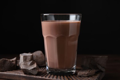 Photo of Fresh yummy chocolate milk on wooden table
