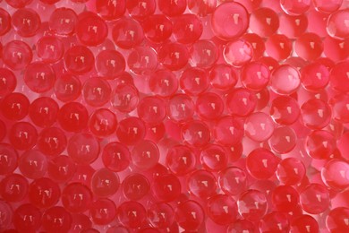 Photo of Top view of red vase filler as background. Water beads
