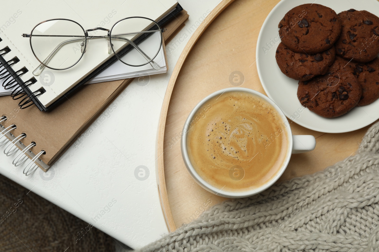 Photo of Cup of hot coffee and cookies on white table, top view. Winter drink