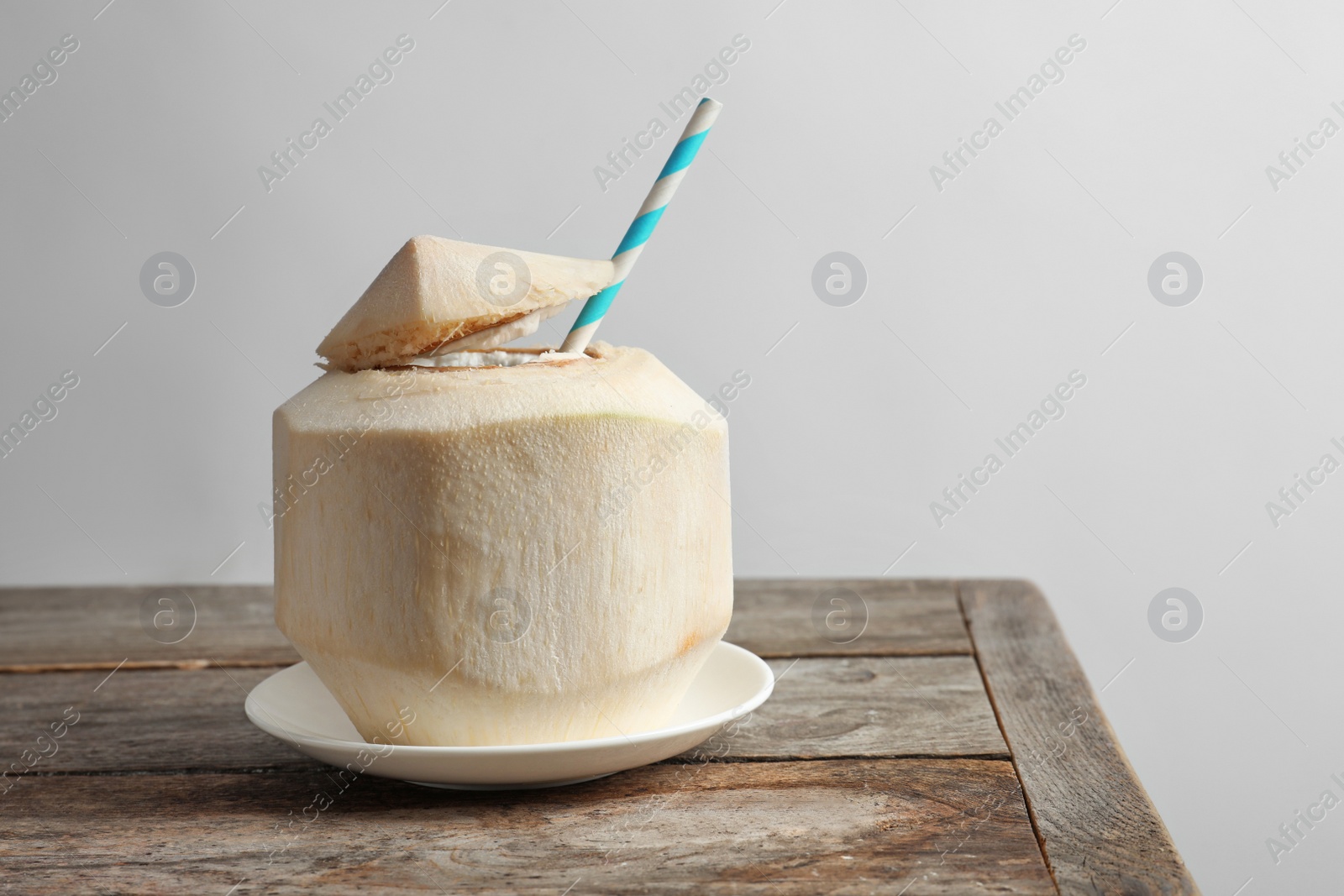 Photo of Fresh coconut drink in nut on table