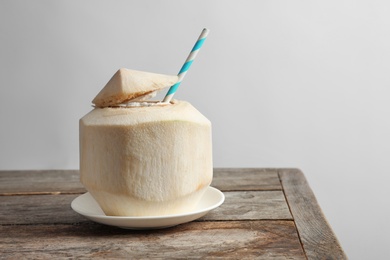 Photo of Fresh coconut drink in nut on table