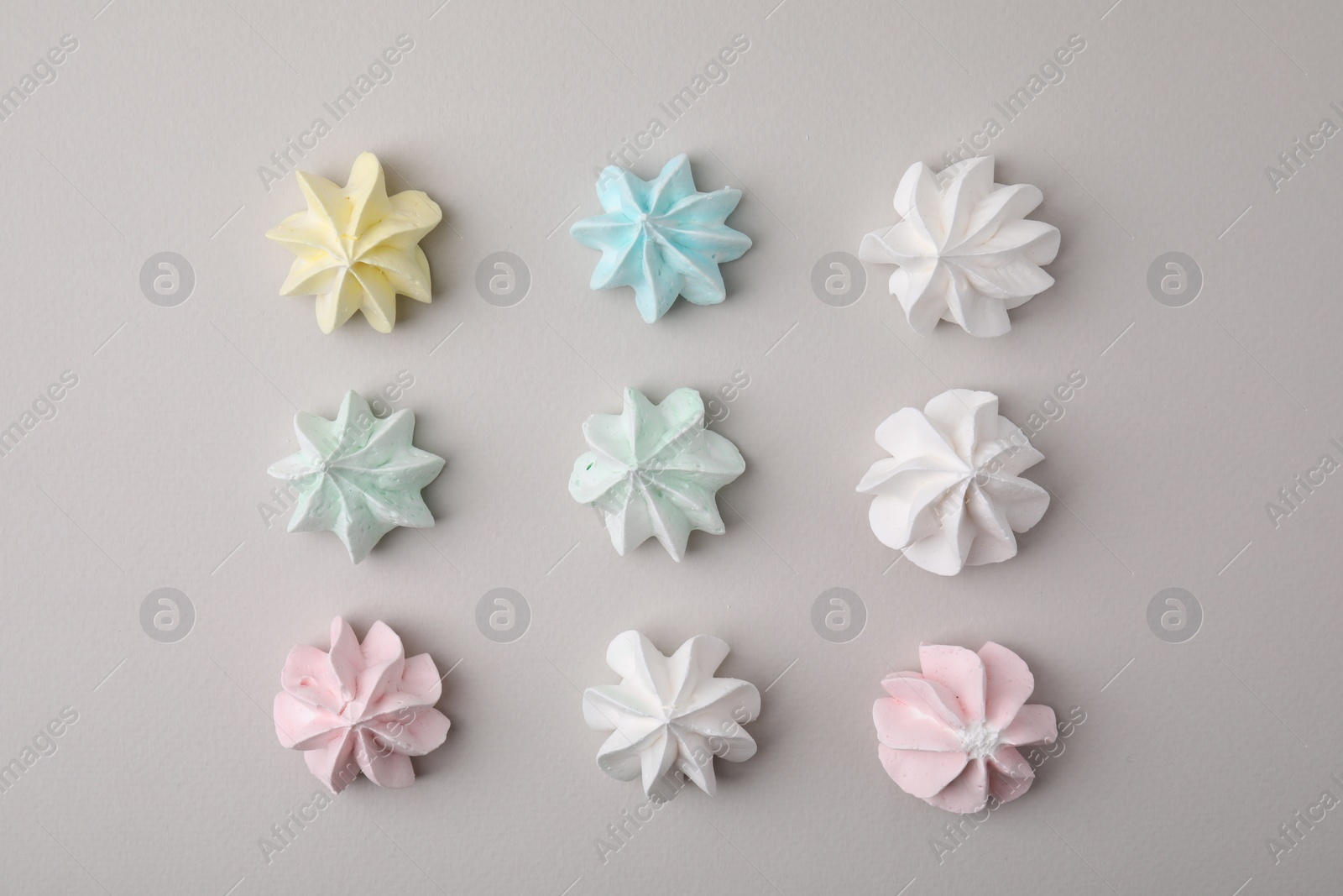 Photo of Delicious meringue cookies on light background, flat lay