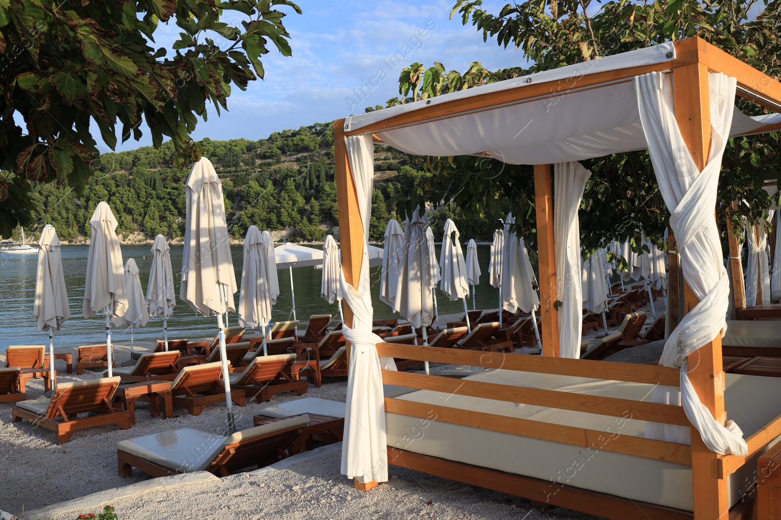 Photo of Many beach umbrellas and sunbeds at resort