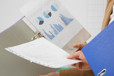 Photo of Businesspeople working with charts in office, closeup