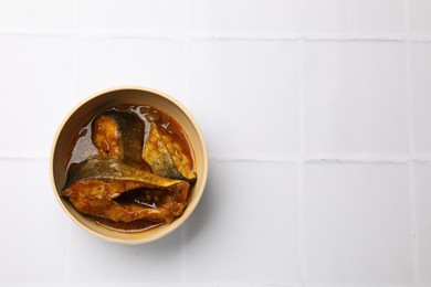 Photo of Tasty fish curry on white tiled table, top view. Space for text. Indian cuisine