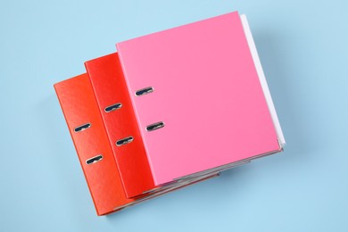 Many office folders on light blue background, flat lay