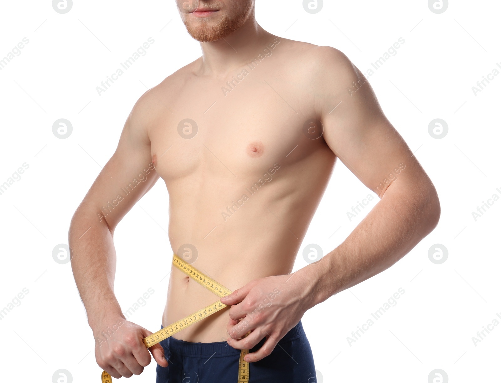 Photo of Young man with measuring tape showing his slim body on white background, closeup