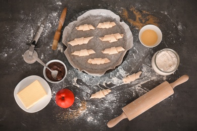 Flat lay composition with ingredients and raw croissants on grey background