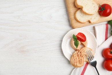 Photo of Fresh bread with delicious meat pate served on white wooden table, flat lay. Space for text