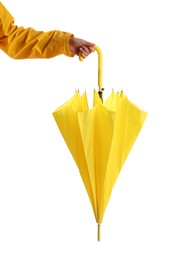 Woman with closed yellow umbrella on white background, closeup