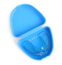 Transparent dental mouth guard in container isolated on white, top view. Bite correction