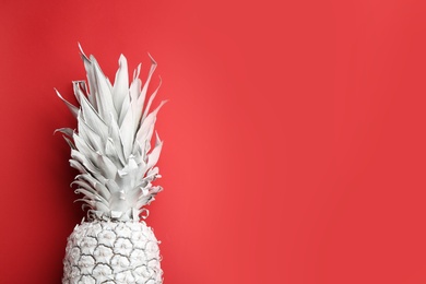 Photo of White pineapple on red background, top view with space for text. Creative concept