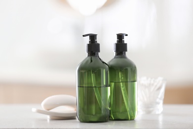 Green soap dispensers on white countertop in bathroom