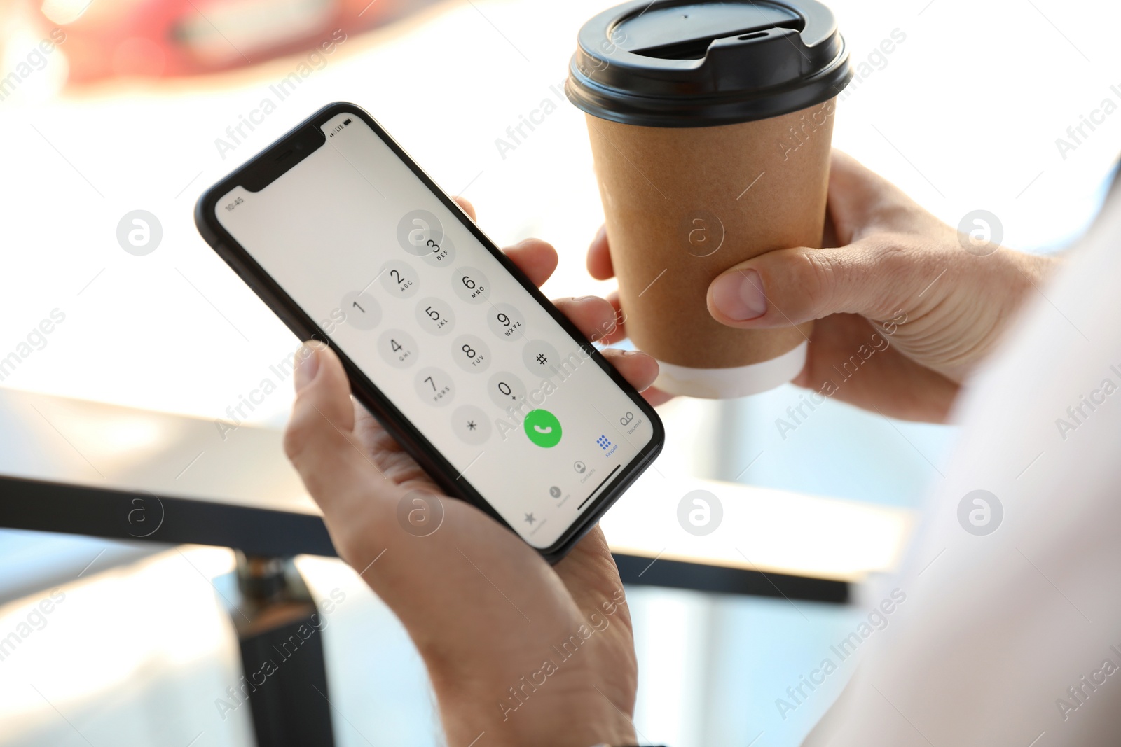 Photo of MYKOLAIV, UKRAINE - MARCH 16, 2020: Man holding iPhone 11 with keypad on screen indoors, closeup