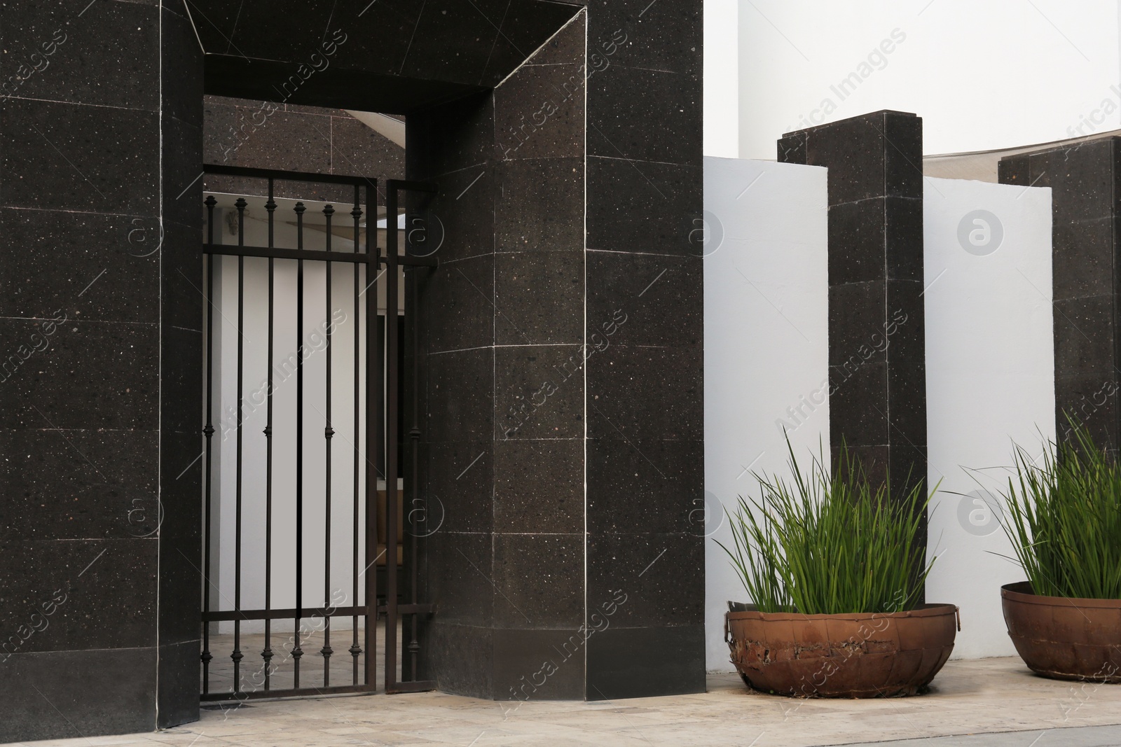 Photo of Entrance of yard with beautiful black metal door