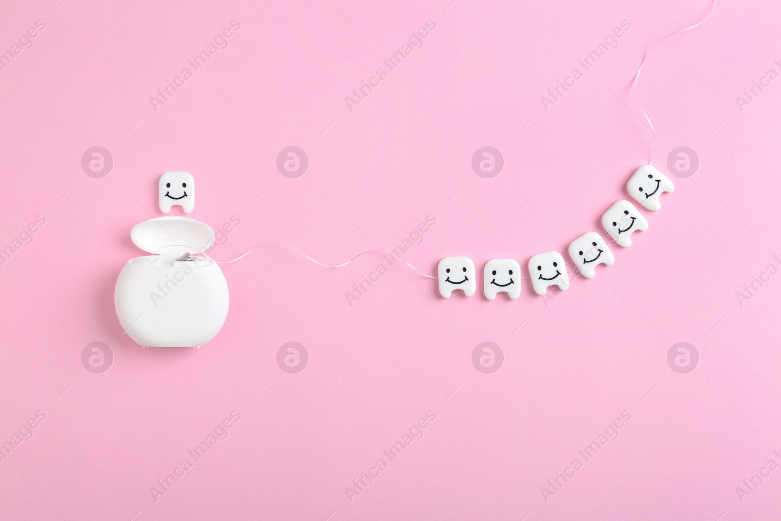 Photo of Flat lay composition with small plastic teeth and dental floss on color background