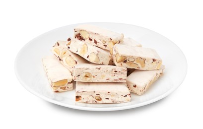 Plate with pieces of delicious nougat isolated on white