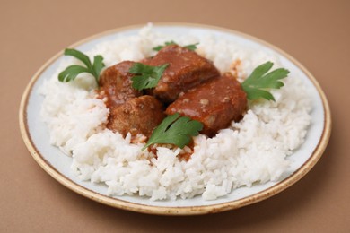 Photo of Delicious goulash with rice on brown background, closeup