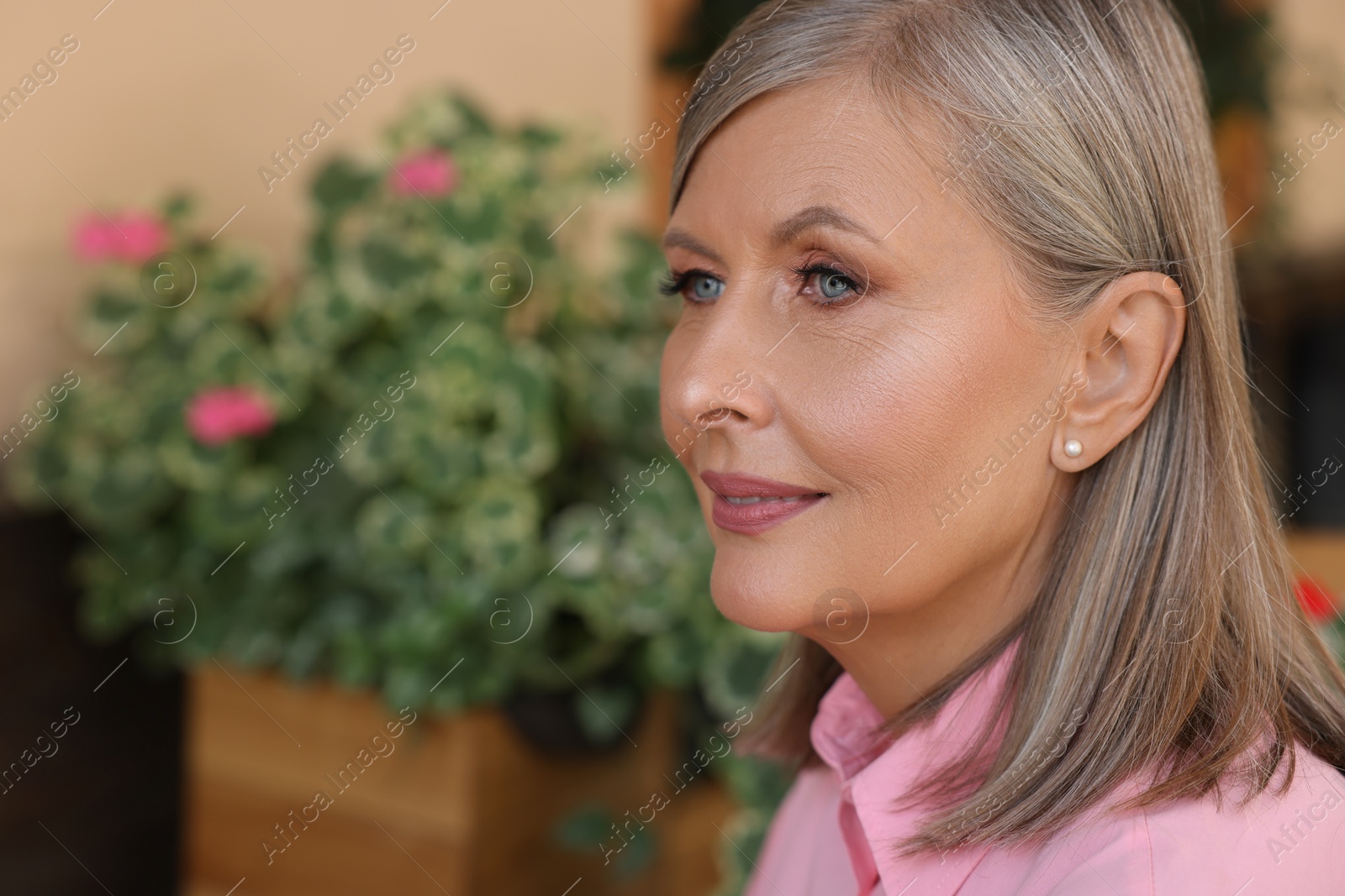 Photo of Portrait of beautiful senior woman outdoors, space for text