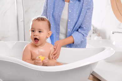 Mother with her little baby in bathroom