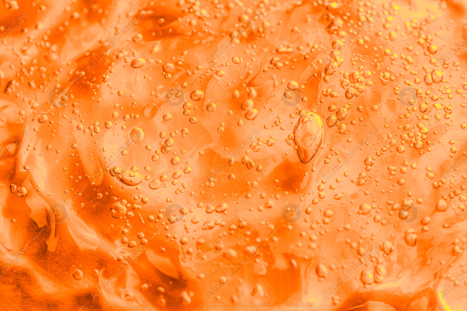 Image of Texture of transparent cosmetic gel as background, closeup. Toned in orange