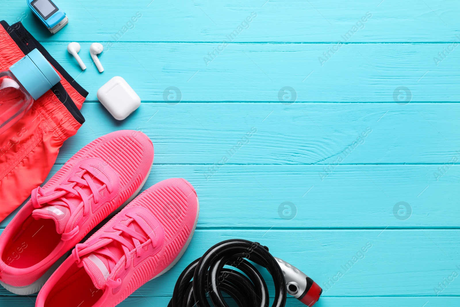 Photo of Flat lay composition with different cycling accessories on turquoise wooden background, space for text