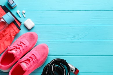 Photo of Flat lay composition with different cycling accessories on turquoise wooden background, space for text