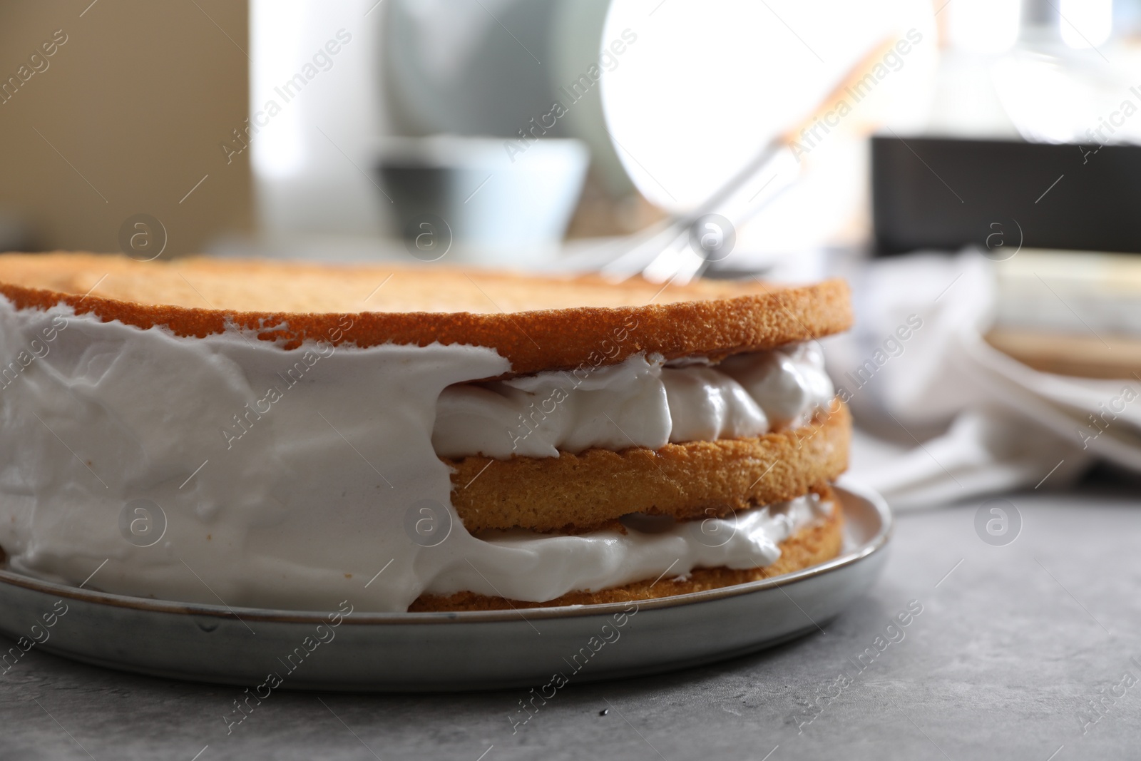 Photo of Delicious homemade layer cake with cream on grey table, closeup