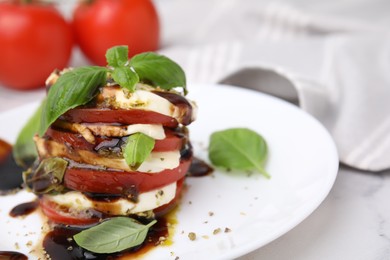 Photo of Stacked Caprese salad with balsamic vinegar on table, closeup. Space for text