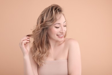 Photo of Portrait of smiling woman on beige background