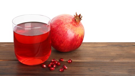Photo of Refreshing pomegranate juice in glass, leaves and seeds on wooden table against white background. Space for text